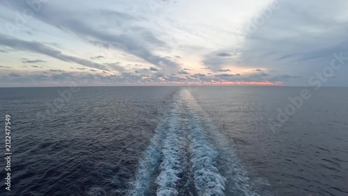 Stunning sunset over calm ocean from cruise ship