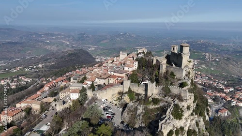 Aerial straight flyover above the historic old town streets and medieval rooftops of San Marino