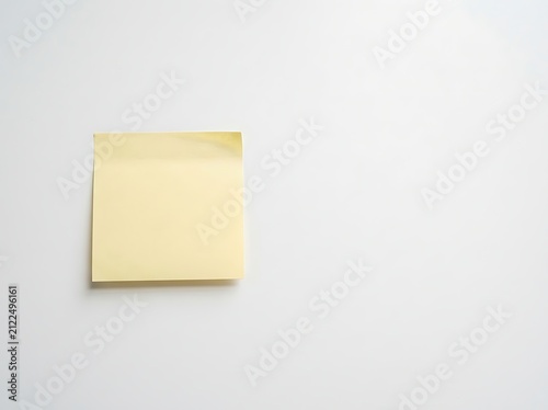 Blank yellow sticky note isolated on white background