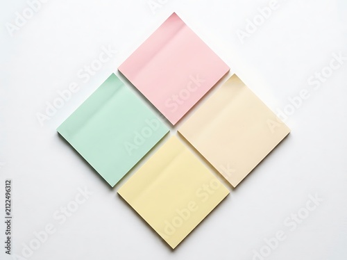 Four colorful blank sticky notes arranged in a diamond shape isolated on white background