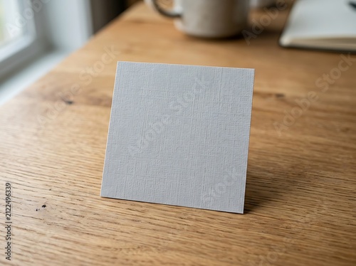 Blank square card mockup on a wooden desk