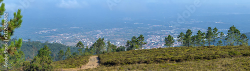 Bild auf Leinwand A scenic trail leads across a mountain ridge overlooking a wide valley town