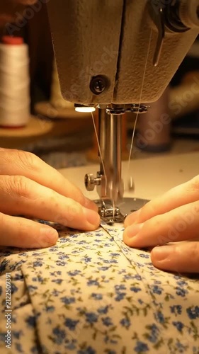 Hands Sewing Floral Fabric on Machine.