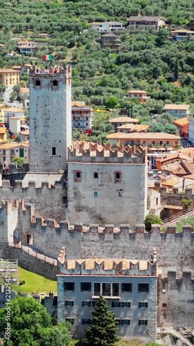 Scaliger Castle on cliff in Malcesine, Lake Garda. Medieval fortress with stone walls and central tower in Italy