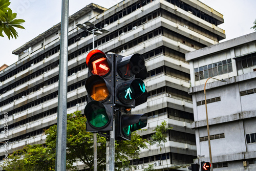 Photography Traffic signal with a red arrow and urban office building