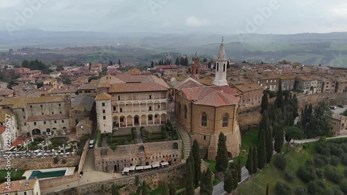 Cinematic drone forward flyover above Pienza Cathedral showcasing the historic old town streets
