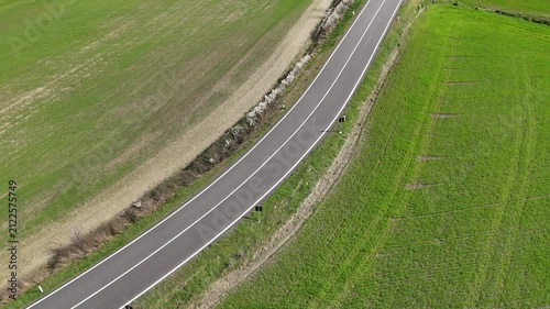 Drone pan up and aerial flyover of famous cypress tree lined road at Poggio Covili in Val d Orcia Tuscany