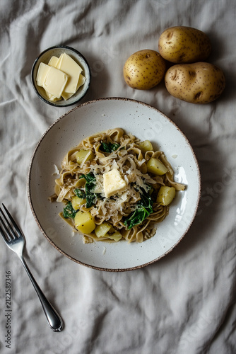 TRADITIONAL ITALIAN PIZZOCCHERI PASTA WITH POTATOES CABBAGE AND BUTTER TOP VIEW