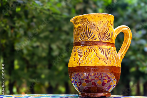 Cuadro en lienzo Traditional Handmade Yellow Glazed Moroccan Ceramic Pitcher on a Mosaic Table