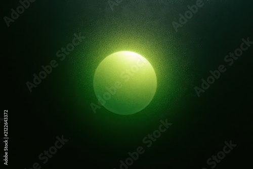 Abstract glowing green sphere in dark space with particle texture