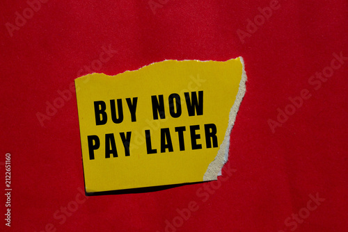 Konstfotografi Yellow torn paper with buy now pay later message against a vibrant red backgroun