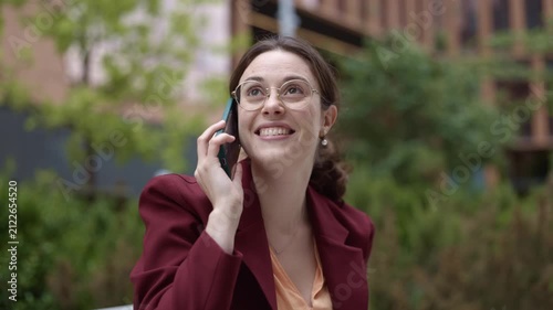 Happy businesswoman talking on the phone outdoors