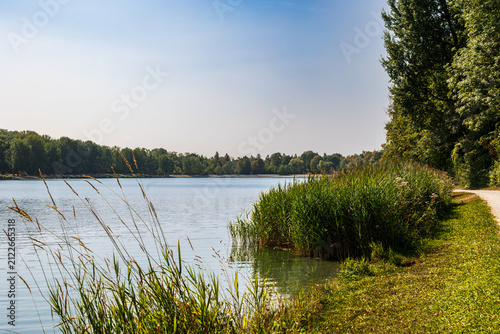 Scenic lake with grassy shore and trees, Germany, Bavaria, Augsburg Kuhsee, 2 August 2026