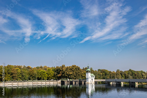 Lake dam with tower and trees under blue sky, Germany, Bavaria, Kuhsee, Augsburg, 2 August 2026