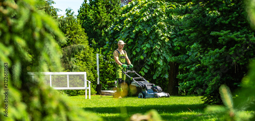 Gardener mows lawn in peaceful backyard on a sunny day