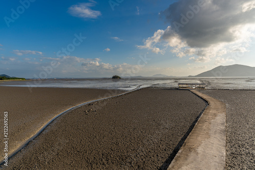 Wide Coastal Mudflat Under a Blue Sky at Waon Beach