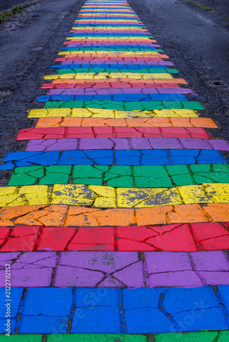 Rainbow painted stone pavement on Regnbogagatan street in Seydisfjordur, Iceland