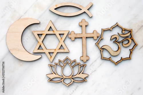 A composition of religious symbols representing interfaith dialogue: the Christian cross, the Star of David, the Islamic crescent, the Hindu Om, and the Buddhist lotus. 
