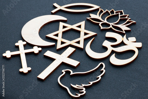 A symbolic composition depicting interfaith dialogue, featuring the major religious symbols: the Christian cross, the Star of David, the Islamic crescent, the Hindu 