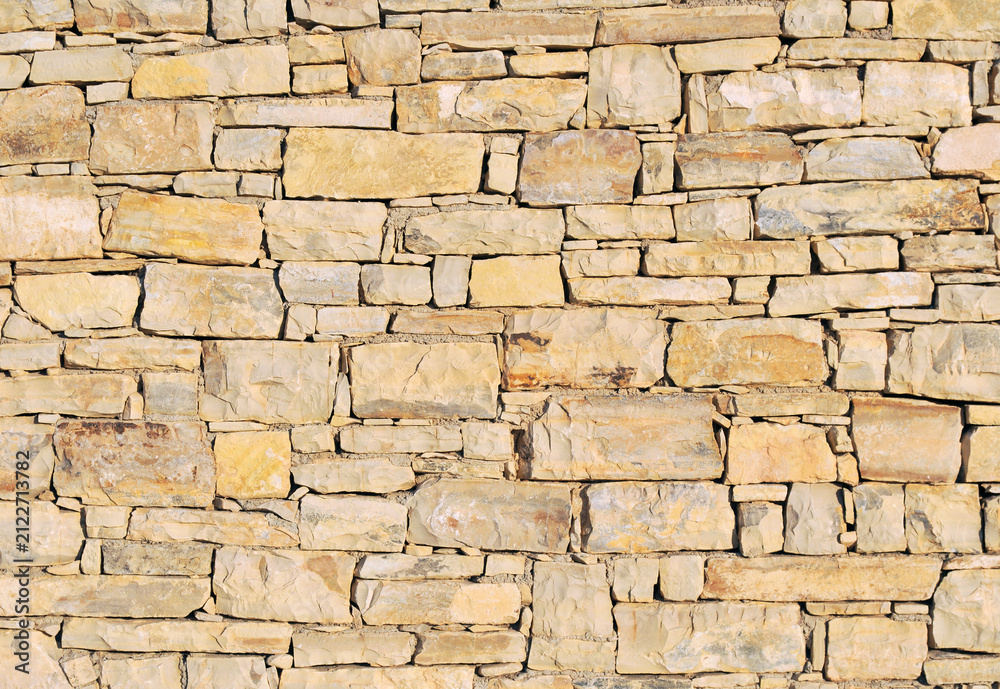 Fototapeta premium old dry stone wall close up