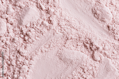 Close up texture background of fine soft pink cosmetic powder loose makeup