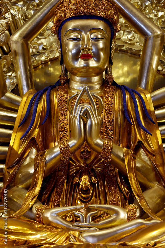 Fototapeta premium Vietnam Quoc Tu Pagoda. Guanyin, or Quan Am, the bodhisattva of universal compassion with a thousand arms. Her main hands are joined in the anjali mudra. Ho Chi Minh City, Vietnam.