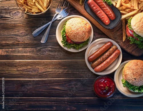 tailgate food game day party outdoor catering concept with hot dogs and burgers on picnic table