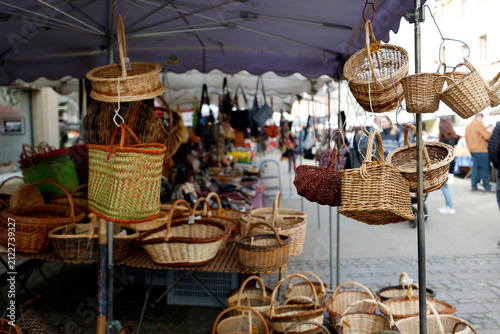 Fotografie Traditional handmade baskets hanging and stacked under a canopy at a street market