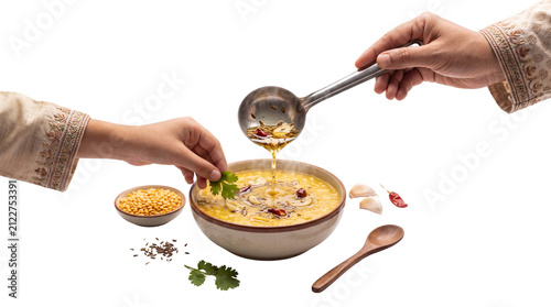 Traditional Indian dal tadka with pouring oil, hands garnishing yellow lentil soup with cilantro, authentic homemade spicy dal fry isolated PNG with Transparent Background