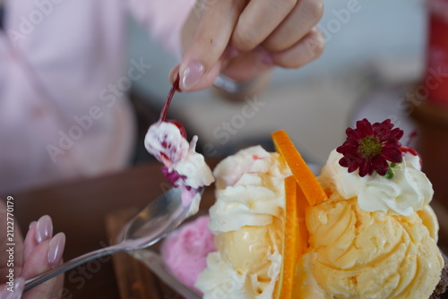 Woman Hands Writing in Notebook and Eating Delicious Ice Cream Bingsu Dessert with Spoon at Cafe, Lifestyle Working and Dessert Concept