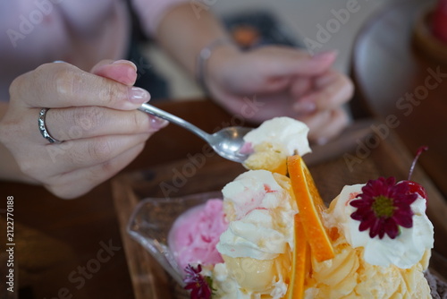 Woman Hands Writing in Notebook and Eating Delicious Ice Cream Bingsu Dessert with Spoon at Cafe, Lifestyle Working and Dessert Concept