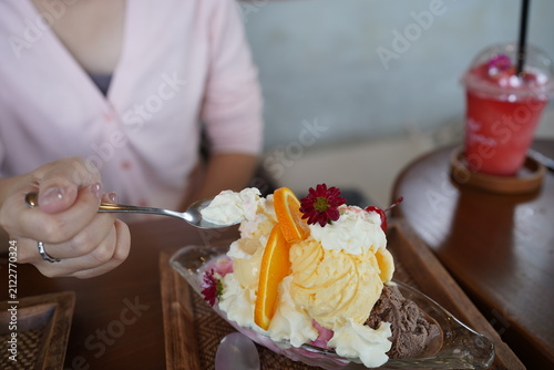 Woman Hands Writing in Notebook and Eating Delicious Ice Cream Bingsu Dessert with Spoon at Cafe, Lifestyle Working and Dessert Concept