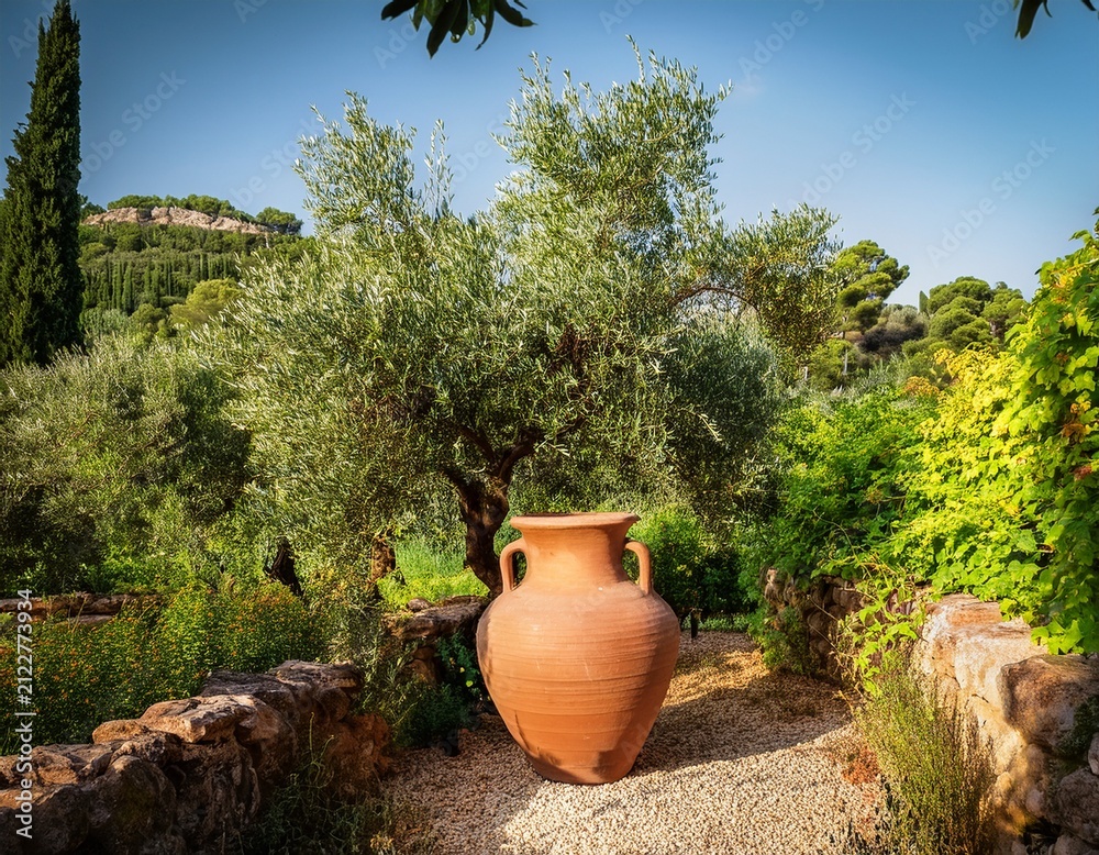 Obraz premium traditional clay amphora in a lush mediterranean garden