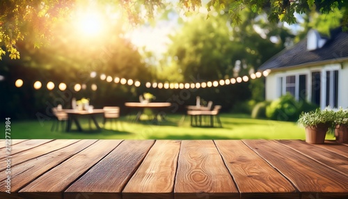 summer time party in backyard with empty wooden table and blurred background