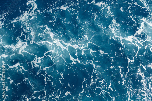 Close-up of blue sea waves with white foam