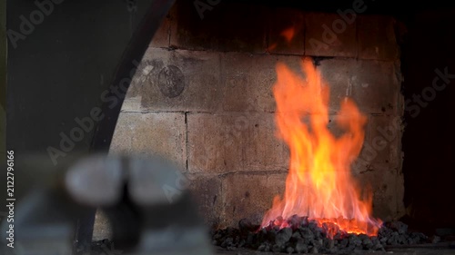 The Intense Dance of Flames: Capturing the Transformation of Coals in a Blacksmith's Forge from Fiery Embers to Blazing Inferno