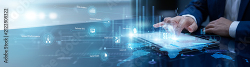 Marketing expert touches the tablet to refine SEO strategy, monitoring search engine performance and keyword trends on a global map to boost online visibility and traffic growth.