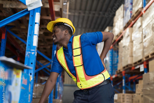 Warehouse, deposit or store. African American warehouse worker have accident during working in warehouse. Worker have sick while working