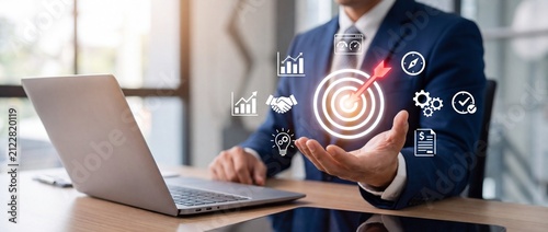 Business professional in a suit interacting with digital target and analytics icons during a presentation with businessman formal suit engaging digital icons representing analytics