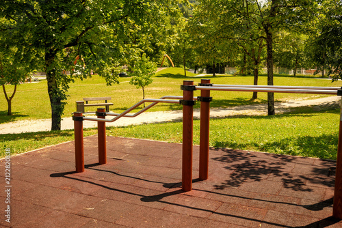 Quadro su tela Parallel dip bars on rubber flooring at an outdoor workout park on a sunny summer day