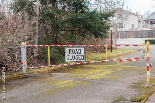 A close-up of a red and white striped metal barrier gate with a Road Closed sign. - March, 09 2026, Milton WA, USA