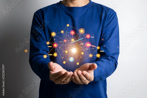 Man holding glowing global digital network nodes in open hands