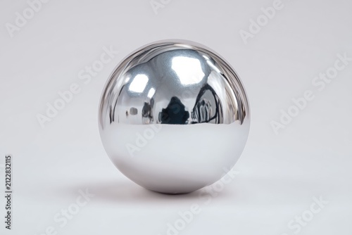 Shiny mirror balloon photographed in studio lighting highlighting glossy chrome aesthetic.