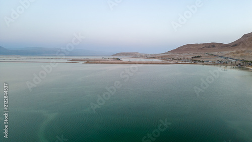 Fotografía aerial view of calm dead sea water evaporation ponds and salt dikes at dusk isra