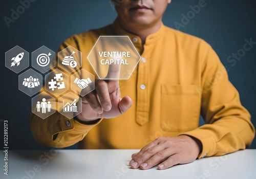 Businessman touching a digital screen interface with venture capital investment icons display