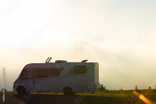 Camper van parked with sunrise over Pyrenees mountains