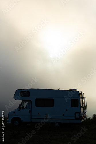 Camper van silhouette at sunrise in Superbagneres, Pyrenees, France