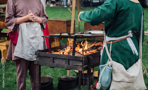 Фотография Medieval Festival Cooks Preparing Food Over Open Fire Pit Outdoor Kitchen Histor