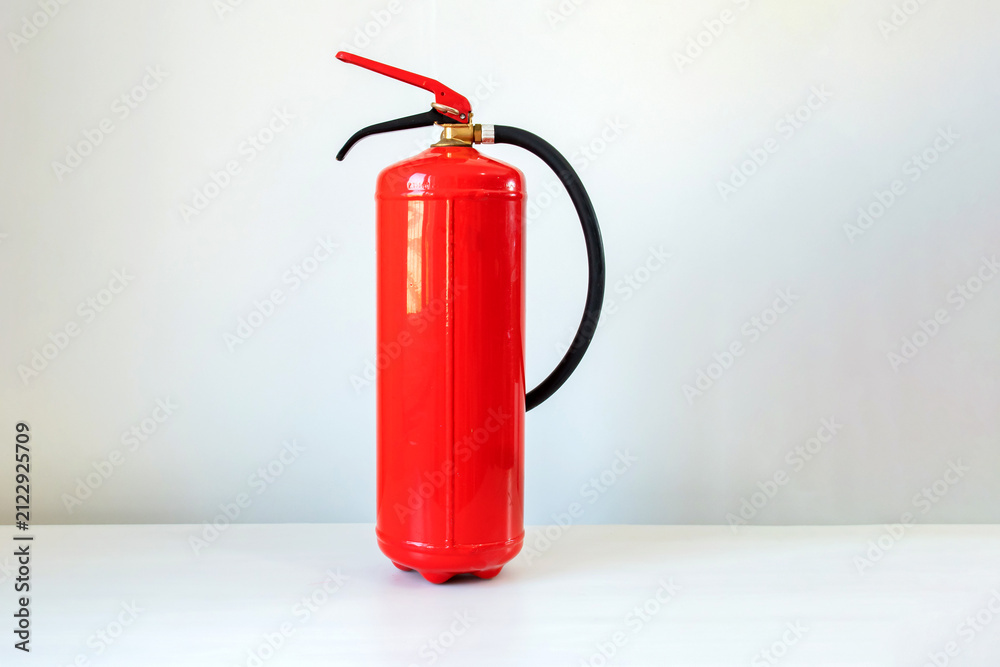 Obraz premium Fire extinguisher, isolated on a white background. Fire safety, emergency preparedness, fire prevention, occupational health and safety