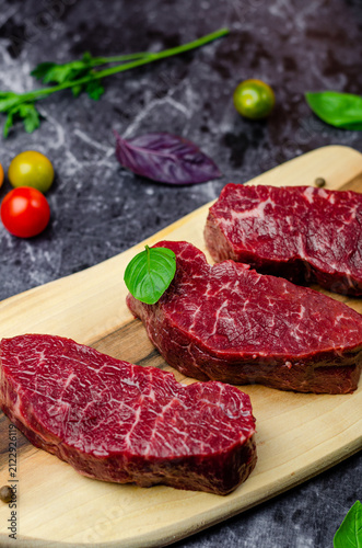 raw meat steak on wooden board